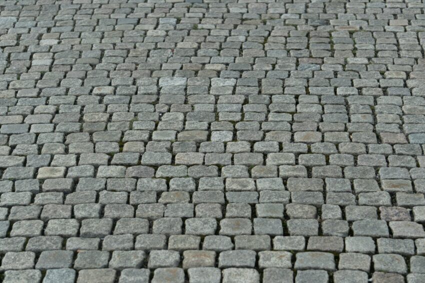 a close up of a brick road with a stop sign on it